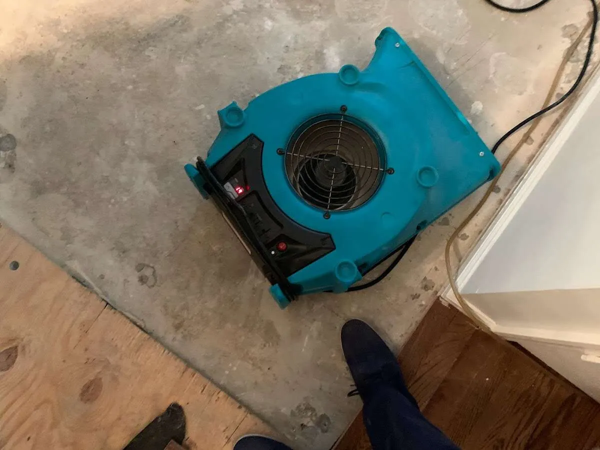 Air mover drying subfloor during Leak Detection & Repair in Monticello